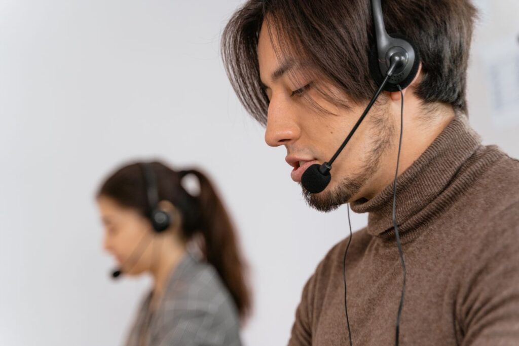 Focused call center employees wearing headsets, assisting customers with exceptional service.